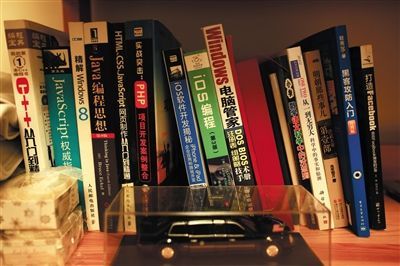 ▼汪正揚的書桌旁放著很多計算機編程的書籍。汪正揚電腦編程等技術全部自學。 