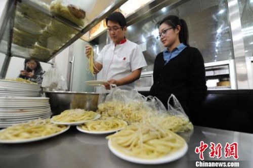 &ldquo;海歸&rdquo;碩士情侶楊洋和閔焱菲正忙碌著店里的生意。　