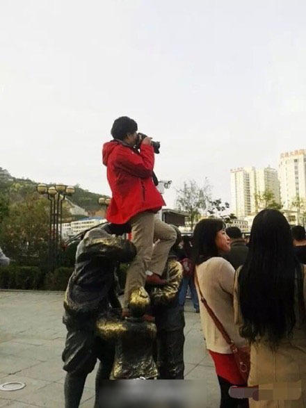 陜西延安一名女游客為拍照坐紅軍雕塑頭上