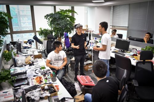 在深圳科技園的大疆創新總部，民用無人機領軍者汪滔（中）參與研發人員的討論（2015年5月22日攝）。